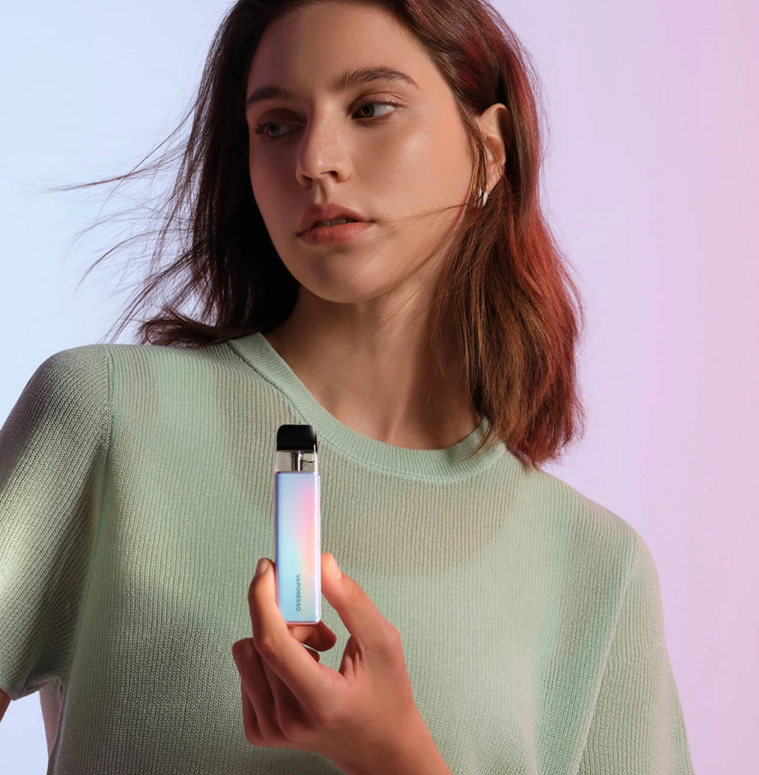 a woman holding the vaporesso xros 5 mini vape kit
