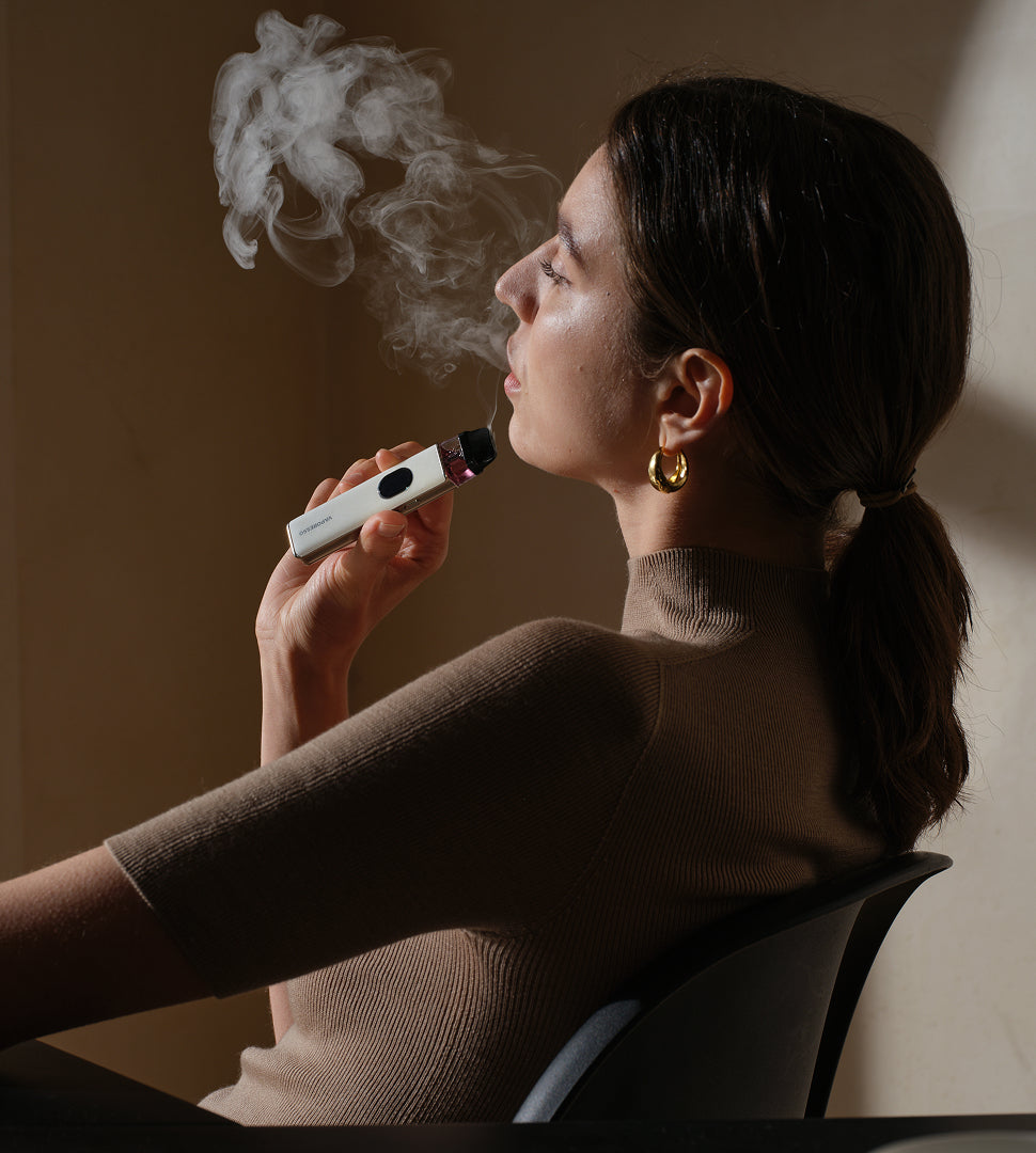 a woman vaping the vaporesso xros 5 pod vape kit